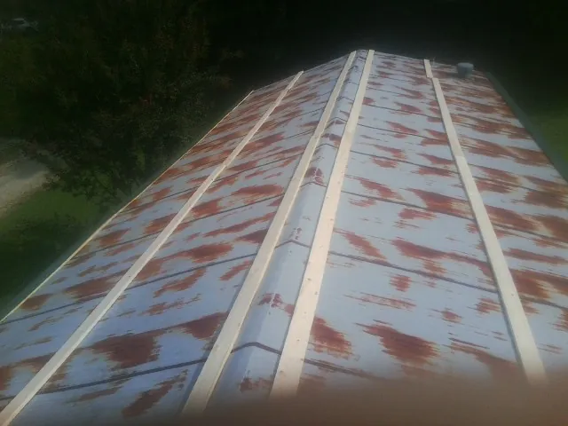 Rusted metal roof panels with new wood purlins before replacement — Storm Damage Roof Repair in Homer Glen by Roofing Brothers