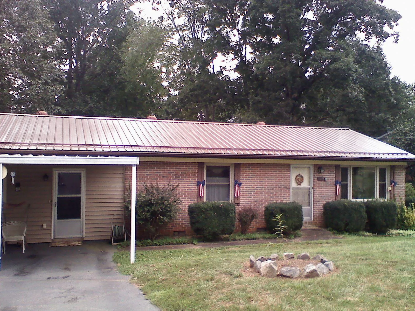 Bronze metal roof and carport on a brick ranch home — Roof Repair work by our crew in Homer Glen